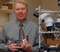 Ross Secord holding the jawbone with teeth of  the extinct hippo-like mammal Coryphodon.