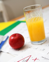 Photo of an apple and an orange on a mathematics exam graded as an A+.