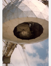 Photo showing the inside the dome of the Arecibo Observatory, where there is a pulsar detector.