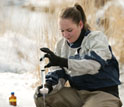 Photo of University of Wyoming student Sarah Ann Gregory gathering water samples for research.