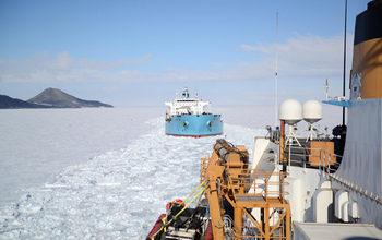 The USCGC Polar Star escorts a tanker through the sea ice of McMurdo Sound.