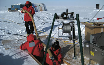 researchers sampling ice at the South Pole.