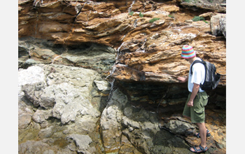 Photo of Cristiano Collettini looking at the Zuccale Fault on the Isle of Elba, Italy.