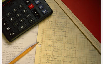 Photo of a calculator, pencil and notepaper.