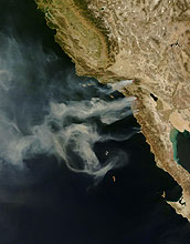 Satellite image of smoke from Southern California wildfires billowing over the Pacific Ocean.