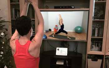woman exercising in front of monitor