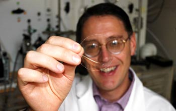 Benny Freeman of The University of Texas at Austin holds a sample of the new membrane.