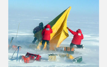 Photo of researchers setting up an Antarctic field camp.