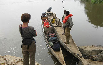 Students with equipment and boats on the Ogooué river in Gabon