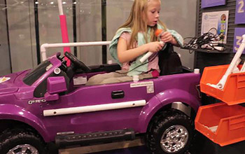 Modified toy cars allow mobility-impaired children to explore their environment.
