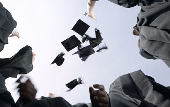 Graduates with caps in the air
