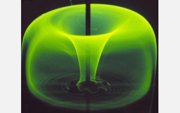 A fluorescent dye injected into a tank of stirred liquid creates a "green apple" pattern.