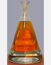 Photo of green gasoline siting above water in an Erlenmeyer flask.