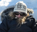 Photo of student Alexandra Schmidt taking notes during an experiment on the Greenland Ice Sheet.