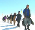 Photo of a line of students walking on Greenland's ice sheet.