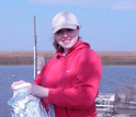Photo of LSU graduate student Erica Simmons collecting water, sediment and oysters in Cocodrie, La.