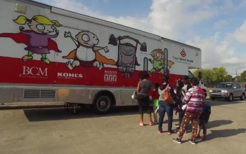 people waiting in line at a health truck