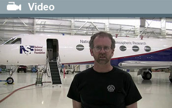Bruce Daube standing in front of NSF's Gulfstream V aircraft with word Video and video icon.