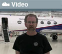 Bruce Daube standing in front of NSF's Gulfstream V aircraft with word Video and video icon.