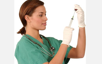 Photo of a woman inserting a hypodermic needle into a vial.