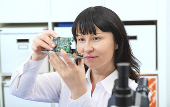 woman holding a piece of hardware