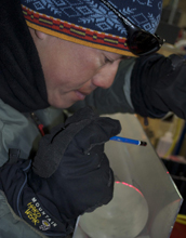 Photo of a researcher examining an ice core.