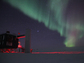 The aurora australis shines above NSF's IceCube Neutrino Observatory at NSF's Amundsen-Scott South Pole Station.