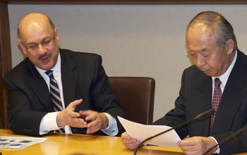 Farnam Jahanian and Masao Sakauchi talking during a meeting