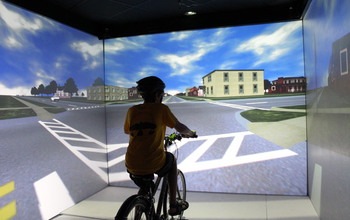 Kid on a stationary bike in the Hank Virtual Environments Lab