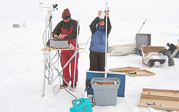 Photo of scientists installing a monitoring station in Greenland