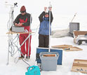 Photo of scientists installing a monitoring station in Greenland