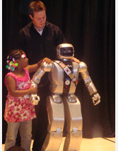 A little girl is charmed during the humanoid robot (HUBO) Jaemi's unveiling and visit to museum