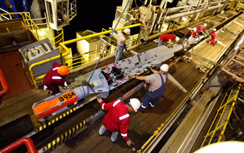 JOIDES Resolution crew members prepping a CORK for installation beneath the seafloor.