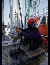 South Pole worker attaching a photomultiplier tube