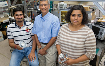 Photo of Ankit Kalani, Satish Kandlikar and Kirthana Kripash holding a LED light cooling device.