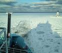 R/V Sikuliaq backs up and rams through to break snow-packed ice.