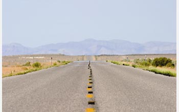 Photo of a paved road in a valley in the Great Basin.