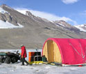 Researcher at Antarctica's Dry Valleys LTER Site, with tent and equipment