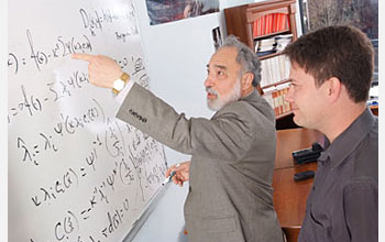 Photo of two men in at a whiteboard