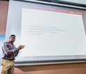 student in front of slide presentation