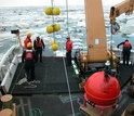 Researchers deploy Mooring flotation balls during a research expedition.