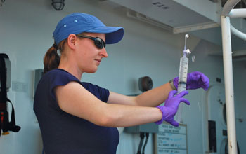 Photo of scientist Molly Redmond with a sample taken as part of the Gulf oil spill microbes study.