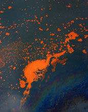 Photo of oil slick at the sea's surface containing orange-colored older oil and fresher oil sheen.