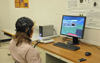 Person wearing a hat with electrodes controls a 3d virtual helicopter