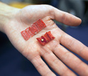 Photo of ingestible origami robot shown in the palm of a hand