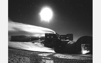 A full moon glows above the new and the old buildings at Amundsen-Scott South Pole Station