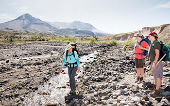 Carri LeRoy teaches students about aquatic and terrestrial environments at a stream near Mount St. Helens