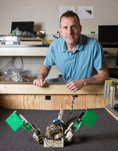 photo of Georgia Tech Associate Professor Dan Goldman with the MuddyBot robot