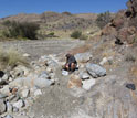 Photo of scientist Paul Bierman sieving a river bed to extract the medium sand fraction.