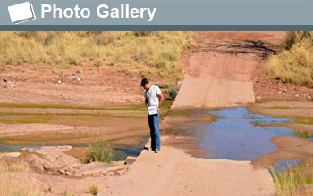 Kyle Nichols viewing a wet river crossing with words Photo Gallery and photo icon.